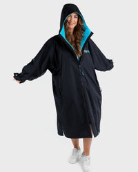 Woman wearing Black Blue dryrobe® Advance Long Sleeve with hood up