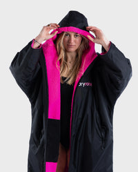 Woman wearing Black Pink dryrobe® Advance Long Sleeve with hood up