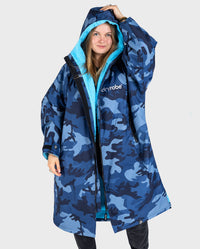 Woman wearing dryrobe Advance Long Sleeve change robe in Blue Camo Blue with hood up 