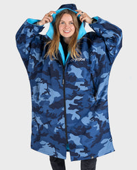 Woman pulling up hood on dryrobe Advance Long Sleeve change robe in Blue Camo Blue