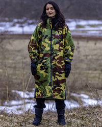 Woman stood outside, wearing Camo Grey dryrobe® Advance Long Sleeve and dryrobe® Thermal Gloves and Boots