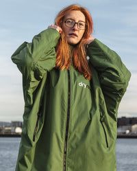 Woman with glasses wearing Forest Green dryrobe® Advance Long Sleeve