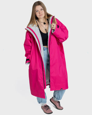 Woman wearing dryrobe Advance long sleeve changing robe in Pink Light Grey