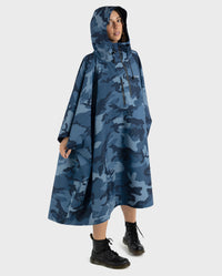 Woman wearing  Blue Camo dryrobe® Waterproof Poncho with hood up 