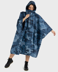 Woman leaning on one leg wearing  Blue Camo dryrobe® Waterproof Poncho 