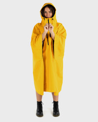 Woman wearing Yellow dryrobe® Waterproof Poncho  wiht hood up 