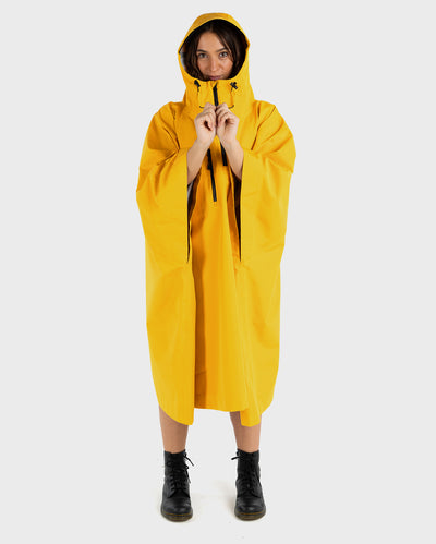 Woman wearing Yellow dryrobe® Waterproof Poncho  wiht hood up 