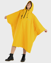 Woman stood with arms out to the side, wearing Yellow dryrobe® Waterproof Poncho