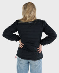 Woman with back to the camera, wearing dryrobe® Mid-Layer Jacket