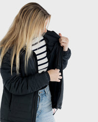 Woman wearing dryrobe® Mid-Layer Jacket, using internal zip-fastened chest pocket