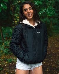 Woman stood in trees, wearing dryrobe® Mid-Layer Jacket
