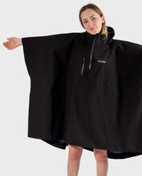Girl wearing Black Kids dryrobe® Waterproof Poncho with arms out to the side