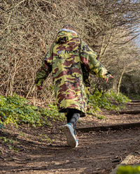 Girl walking up a path wearing Camo Grey dryrobe® Advance Kids Long Sleeve