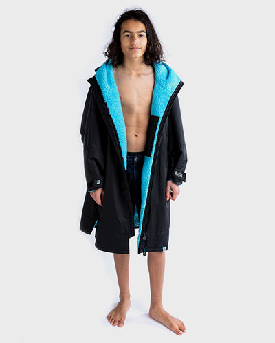 Boy wearing Black Blue dryrobe® Advance Kids Long Sleeve unzipped