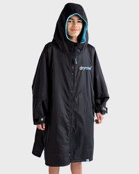 Boy wearing Black Blue dryrobe® Advance Kids Long Sleeve with hood up 