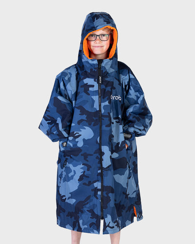 Boy wearing dryrobe Advance Long Sleeve Changing robe in Blue Camo Orange with hood up 