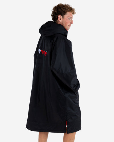 *MALE* Man stood facing sideways wearing dryrobe Advance Long Sleeve changing robe in Black Red