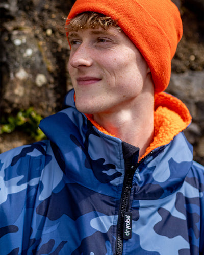 **MALE** Close up of man smiling wearing  orange dryrobe beanie and Blue Camo Orange dryrobe advance long sleeve changing robe