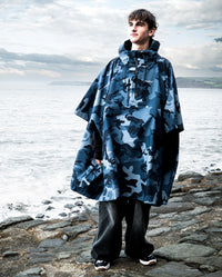 *MALE* stood in front of the sea, wearing  Blue Camo dryrobe® Waterproof Poncho 