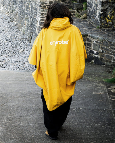 *MALE* walking away from camera wearing  Yellow dryrobe® Waterproof Poncho