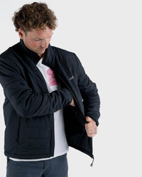 Man reaching into Internal zip-fastened chest pocket of dryrobe® Mid-Layer Jacket