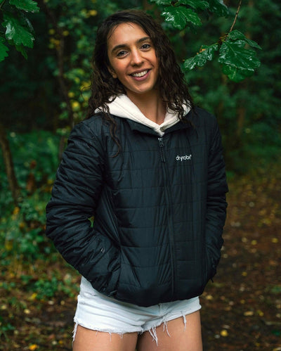 Woman stood in front of trees, wearing dryrobe Mid-layer Jacket in Black 
