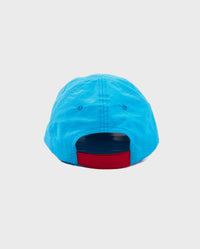 1|Back of blue dyrobe® quick dry cap, showing red velcro adjustable band  