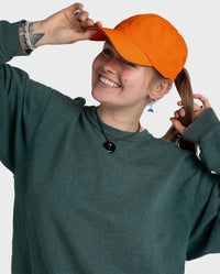 Woman smiling wearing Orange dryrobe Quick Dry Cap