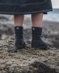 1|View of the back of dryrobe® Eco Thermal Boots, being worn on a beach